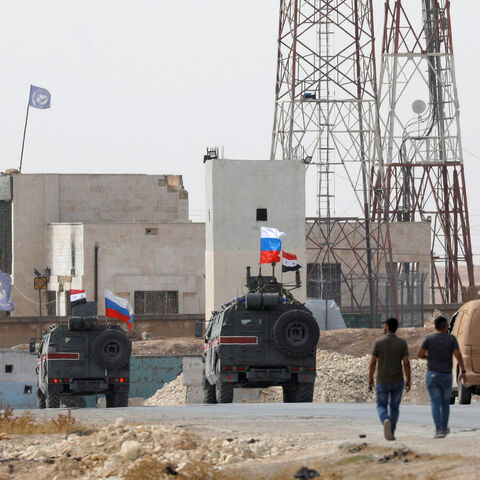 Russian and Syrian national flags flutter on military vehicles near Manbij, Syria October 15, 2019. REUTERS/Omar Sanadiki - RC134A208F00