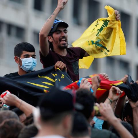 Supporters of Lebanon's Hezbollah leader Sayyed Hassan Nasrallah carry the party's flag in Beirut, Lebanon, October 25, 2019. REUTERS/Mohamed Azakir - RC1916F5C910