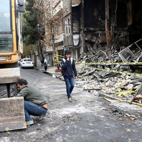 People walk near a burnt bank, after protests against increased fuel prices, in Tehran, Iran November 20, 2019. Picture taken November 20, 2019. Nazanin Tabatabaee/WANA (West Asia News Agency) via REUTERS ATTENTION EDITORS - THIS IMAGE HAS BEEN SUPPLIED BY A THIRD PARTY - RC2GGD9E7BEK