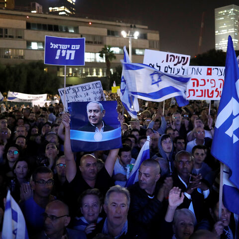 Supporters of Israeli Prime Minister Benjamin Netanyahu take part in a protest supporting Netanyahu after he was charged in corruption cases, in Tel Aviv, Israel November 26, 2019. REUTERS/Amir Cohen - RC28JD9T6J6B