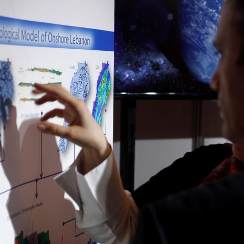 People inspect maps of Lebanon during the third Lebanon International Oil and Gas Summit in Beirut, Lebanon  May 9, 2017. REUTERS/ REUTERS/Mohamed Azakir - RC1AB4C7DE10