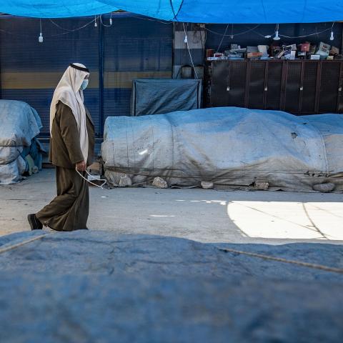 A man wearing a protective mask walks by at an empty market in the Kurdish-majority city of Qamishli in Syria's northeastern Hasakah province, on March 23, 2020, amid measures to curb the spread of the novel coronavirus. - The Kurdish authorities in northeast Syria have not recorded any deaths so far, but have imposed a curfew in a bid to stem any outbreak. (Photo by DELIL SOULEIMAN / AFP) (Photo by DELIL SOULEIMAN/AFP via Getty Images)