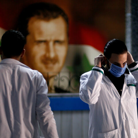 A health worker with a face mask walks inside a hospital, as hospitals enforce a series of measures to prevent the spread of the coronavirus disease (COVID-19), in Damascus, Syria March 19, 2020. REUTERS/Omar Sanadiki - RC20NF9CYGOY