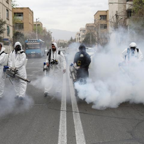 Members of firefighters wear protective face masks, amid fear of coronavirus disease (COVID-19), as they disinfect the streets, ahead of the Iranian New Year Nowruz, March 20, in Tehran, Iran March 18, 2020. Picture taken March 18, 2020. WANA (West Asia News Agency)/Ali Khara via REUTERS ATTENTION EDITORS - THIS PICTURE WAS PROVIDED BY A THIRD PARTY     TPX IMAGES OF THE DAY - RC23NF9FQH2G