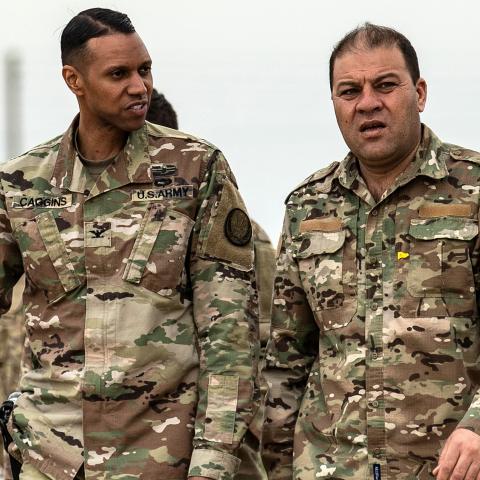 US Army Colonel Myles Caggins (L), official military spokesperson for international military intervention against the Islamic State (IS), and Syrian Democratic Forces (SDF) media spokesman Mustafa Bali (R), visit a military base in Rumaylan (Rmeilan) in Syria's northeastern Hasakeh province on March 6, 2020. (Photo by Delil SOULEIMAN / AFP) (Photo by DELIL SOULEIMAN/AFP via Getty Images)