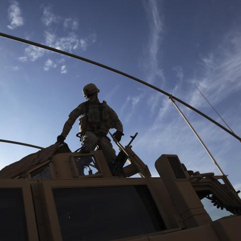 A U.S. Army soldier from the 2nd Brigade 82nd Airborne Division gets out of his Mine Resistant Ambush Protected (MRAP) vehicle after arriving at Camp Kalsu near Hillla, December 5, 2011. The brigade arrived from Taji, which is 20 miles (32 km) north of Baghdad on route to withdrawal from Iraq. REUTERS/Shannon Stapleton   (IRAQ - Tags: MILITARY CONFLICT) - GM1E7C60FJF01