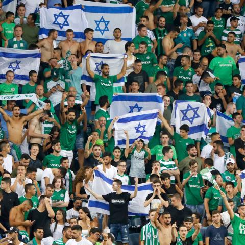 Maccabi fans cheer for their team prior to the second leg of the Europa league second round qualifier football match between Maccabi Haifa and RC Strasbourg at the Sammy Hofer stadium in Haifa on August 1, 2019. (Photo by Jack GUEZ / AFP)        (Photo credit should read JACK GUEZ/AFP via Getty Images)