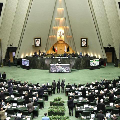 This handout picture provided by the Islamic Consultative Assembly News Agency (ICANA) on January 7, 2020 shows Iranian lawmakers raising their hands to vote during a parliamentary session in Tehran. - Iran's parliament passed a bill designating all US forces "terrorists" over the killing of a top Iranian military commander in a US strike last week. Under the newly adopted bill, all US forces and employees of the Pentagon and affiliated organisations, agents and commanders and those who ordered the "martyrd
