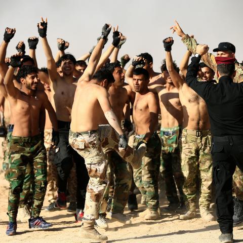 Sunni volunteers, who have joined the Abbas Fighting Division, shout slogans after a field training in Kerbala, Iraq December 20, 2017. Picture taken December 20, 2017. REUTERS/Thaier Al-Sudani - RC116223B030