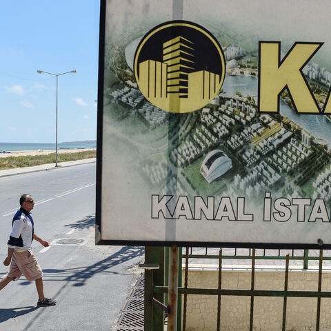 A real estate advertising offers apartments with the view on the canal, in the small coastal village of Karaburun, near Istanbul, on June 12, 2018. - Karaburun's residents are waiting if a controversial new canal that will be built for Istanbul will change the region for the good. The ambitious Canal Istanbul project, first announced by Turkish current President in 2011 when he was prime minister, would begin in the Istanbul district of Kucukcekmece and then head toward Sazlidere reservoir before emerging i
