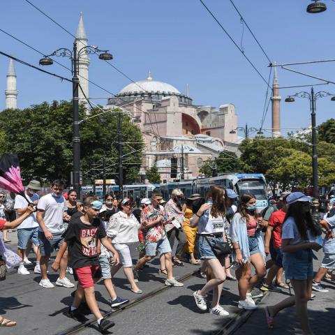 A group of tourists walk past Hagia Sophia as they go toward the historical Sultanahmet district on July 28, 2020 in Istanbul. - The Council of State, the highest administrative court, on July 10, 2020 unanimously cancelled a 1934 decision by modern Turkey's founder Mustafa Kemal Ataturk to turn it into a museum, saying it was registered as a mosque in its property deeds. (Photo by Ozan KOSE / AFP) (Photo by OZAN KOSE/AFP via Getty Images)