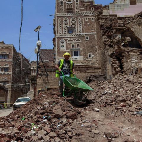 A Yemeni labourer removes the rubble ahead of restoration works on the site of a collapsed UNESCO-listed building following heavy rains, in the old city of the Yemeni capital Sanaa, on August 12, 2020. - Flash floods triggered by torrential rains have killed at least 172 people across Yemen over the past month, damaging homes and UNESCO-listed world heritage sites, officials said. (Photo by Mohammed HUWAIS / AFP) (Photo by MOHAMMED HUWAIS/AFP via Getty Images)