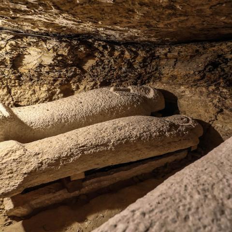 A picture taken on January 30, 2020, shows limestone sarcophagi discovered among many archeological finds in 3000-year-old communal tombs dedicated to high priests, in Al-Ghoreifa in Tuna al-Jabal in the Minya governorate. - Egypt's antiquities ministry unveiled 16 tombs of ancient high priests containing 20 sarcophagi, including one dedicated to the sky god Horus, discovered at the archaeological site, about 300 kilometres (186 miles) south of Cairo. The shared tombs were dedicated to high priests of the g