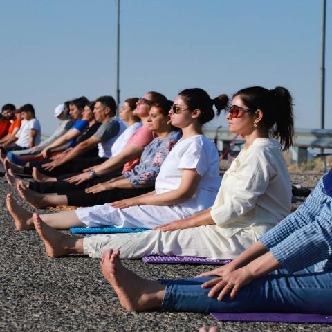 Kurdish Iraqi men and women practice yoga on Mount Azmar, which overlooks the northern city of Sulaimaniyah in Iraq's autonomous Kurdish region, on July 19, 2020. - According to kurdish Iraqi Yoga instructor Muhammad Sherzade, an increasing number of people joined his class since he established his school in the region in 2016, following the outbreak earlier this year of the coronavirus epidemic. (Photo by Shwan MOHAMMED / AFP) (Photo by SHWAN MOHAMMED/AFP via Getty Images)