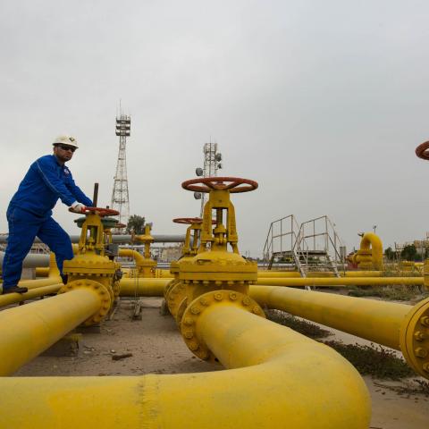 An employee turns a valve at the Nahr Bin Omar natural gas field, north of the southern Iraqi port of Basra on April 21, 2020. (Photo by Hussein FALEH / AFP) (Photo by HUSSEIN FALEH/AFP via Getty Images)