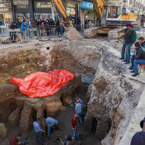 People watch as workers uncover the ruins of a recently discovered Roman archaeological site in the Jordanian capital Amman, on December 14, 2020. - According to local media, the archaeological site was uncovered during works to install a water drainage system. (Photo by Khalil MAZRAAWI / AFP) (Photo by KHALIL MAZRAAWI/afp/AFP via Getty Images)