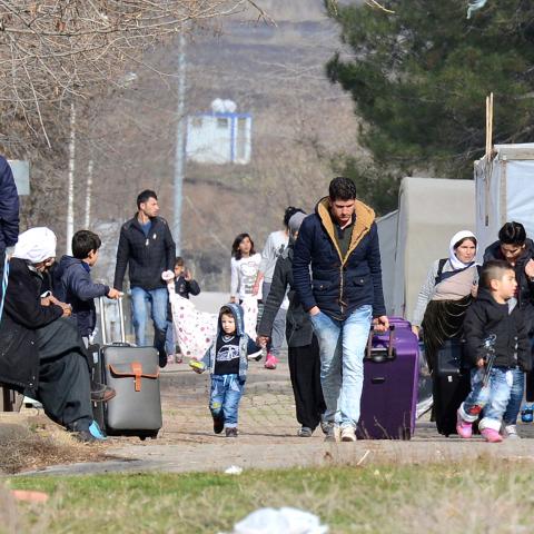 Yazidis refugees carry their belongings on January 3, 2017 in Diyarbakir, southeastern Turkey as they change their refugee camp and move to Midyat, further south.
The population of Yazidis reaches 700,000, the majority residing in northern Iraq where persecution from Islamic State jihadists led to as many as 40,000 Yazidis fleeing their ancestral homes to the Sinjar Mountains in northwestern Iraq, where they were trapped without food or water. / AFP / ILYAS AKENGIN        (Photo credit should read ILYAS AKE