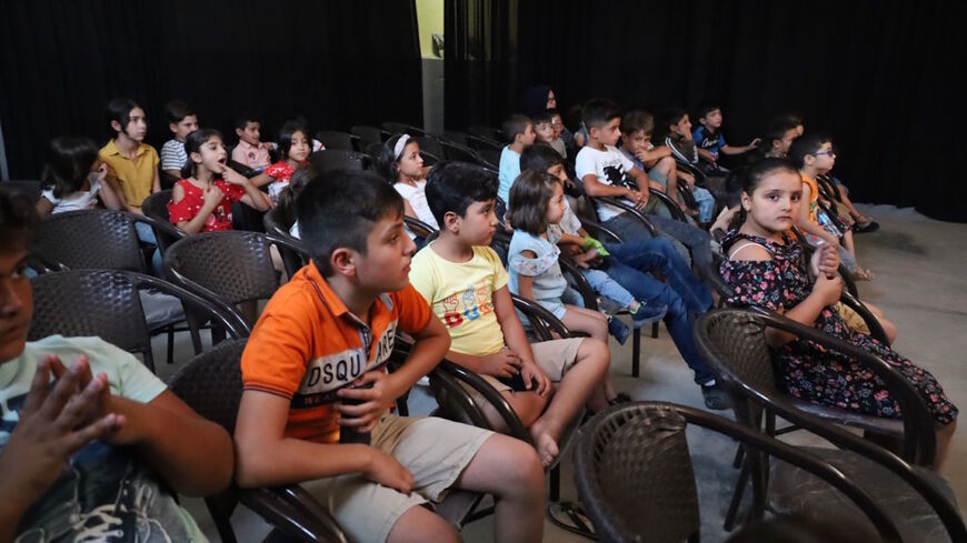 Children watch a film at the cinema in Kulturvan, Nov. 5, 2021. (Alaa Abdelfatah) 