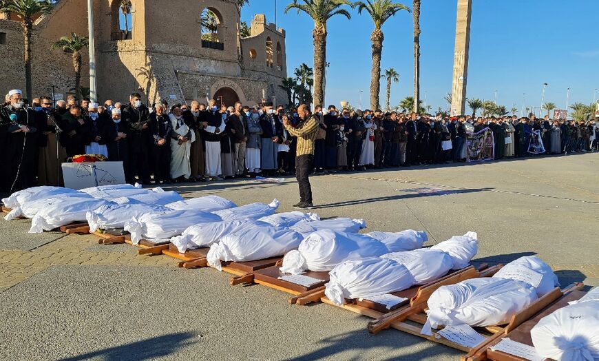 Mourners pray over the bodies found in Tarhuna mass graves in the once militia-controlled town, in Tripoli on January 22, 2020