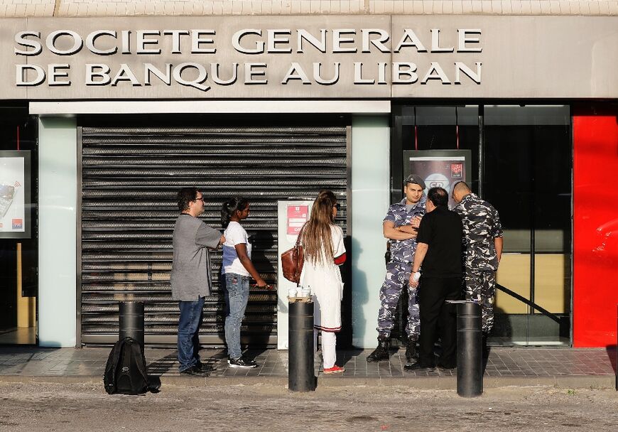 Customers outside a branch of Societe Generale de Banque au Liban