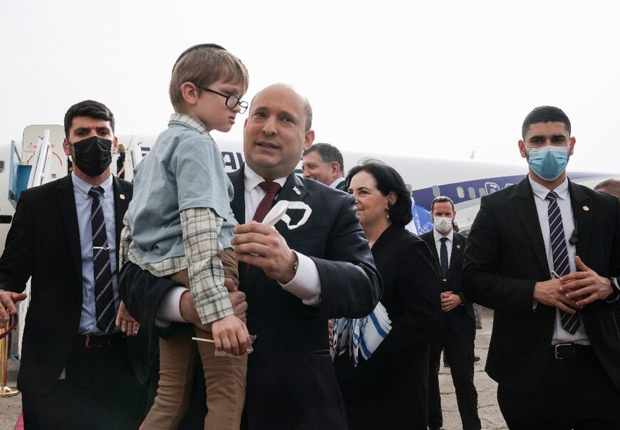 Israeli Prime Minister Naftali Bennett welcomes a group of orphans who were among 300 Ukrainian Jews landing at Ben Gurion Airport