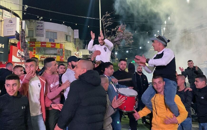 Palestinians celebrate in the West Bank city of Jenin after a shooting attack took place in the Israeli city of Bnei Brak