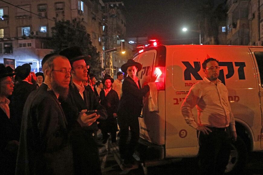 Israeli ultra-Orthodox Jews gather at the scene of the shooting in Bnei Brak near Tel Aviv