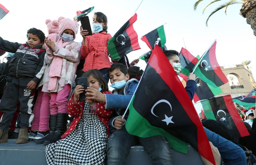 Libyans gather in Tripoli on February 18, 2022 for the 11th anniversary of the uprising that toppled longtime strongman Muammar Kadhafi