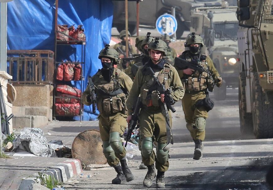 Israeli soldiers patrol on March 30, 2022 a village south of Jenin in the occupied West Bank, reportedly from where Palestinian assailant Diaa Hamarshah left before killing five people during a gun attack in Israel