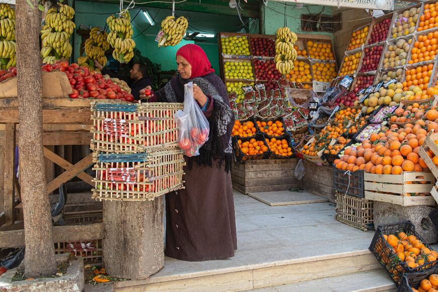 An Egyptian woman shops at a fruit market in Cairo