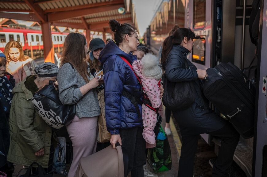Ukrainians fleeing war board a train en route to Warsaw in Przemysl, near the Polish-Ukrainian border, on March 22, 2022