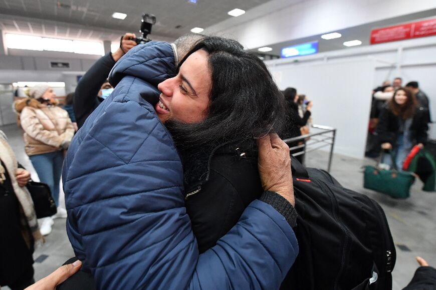 A Tunisian student evacuated from Ukraine is embraced by a relative after arriving on a repatriation flight at Tunis-Carthage airport