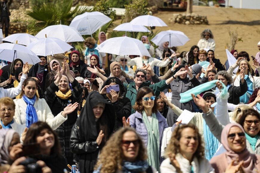 Hundreds of Palestinian and Israeli women activists shared in the poetry of Mahmoud Darwish, planted flags on the Dead Sea's shores and vowed to continue the push for peace