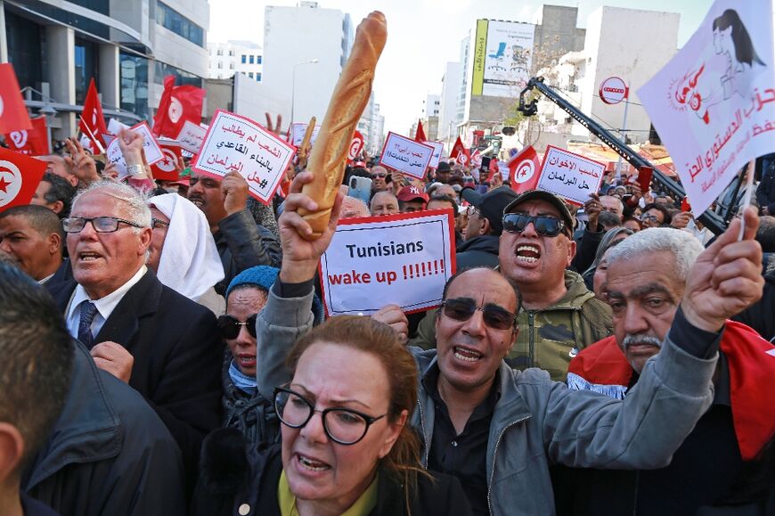 Tunisian opposition supporters take part in a rally against President Kais Saied's power grab and the economic crisis in the North African country, in the capital of Tunis on March 13, 2022