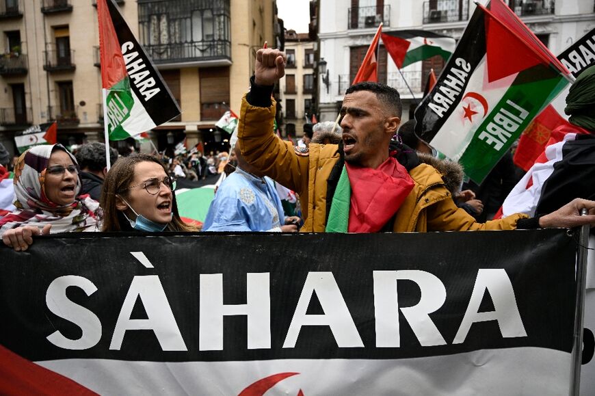 Demonstrators wave Western Sahara flags during a protest against the Spanish government support for Morocco's autonomy plan for Western Sahara, in Madrid, on March 26, 2022