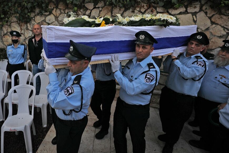 Israeli police officers carry the coffin of Israeli Arab policeman Amir Khoury, 32, one of five people killed in a shooting attack in the religious town of Bnei Brak