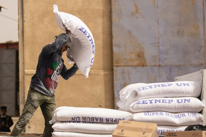 A worker piles up bags of flour inside a warehouse in Iraq's southern port city of Basra