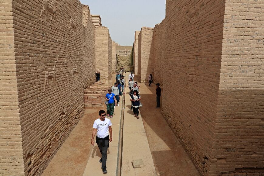 Tourists visit the ancient city of Babylon