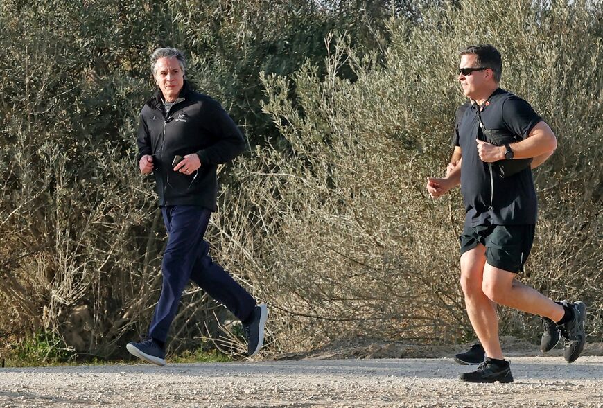 US Secretary of State Antony Blinken, left, jogs at Sde Boker in the southern Negev desert in the morning on March 28, 2022
