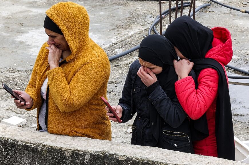 Relatives of Palestinian Alaa Shaham mourn from a rooftop during his funeral at the Qalandia refugee camp south of Ramallah in the occupied West Bank
