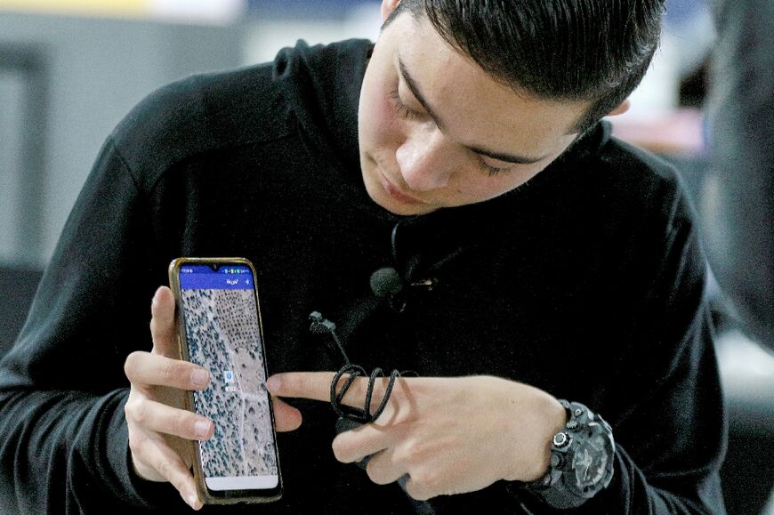 Zain Abu Rumman, an 18-year-old Jordanian student, demonstrates the mobile app for his "SPS Watch" -- a tracking device for the elderly those with special needs that has an eight-day battery life and is resistant to water, heat and breakage