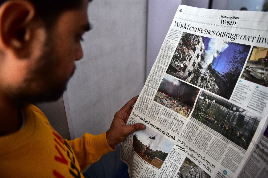 A man reads a newspaper featuring news of the Russian invasion of Ukraine in Allahabad, India on February 25, 2022