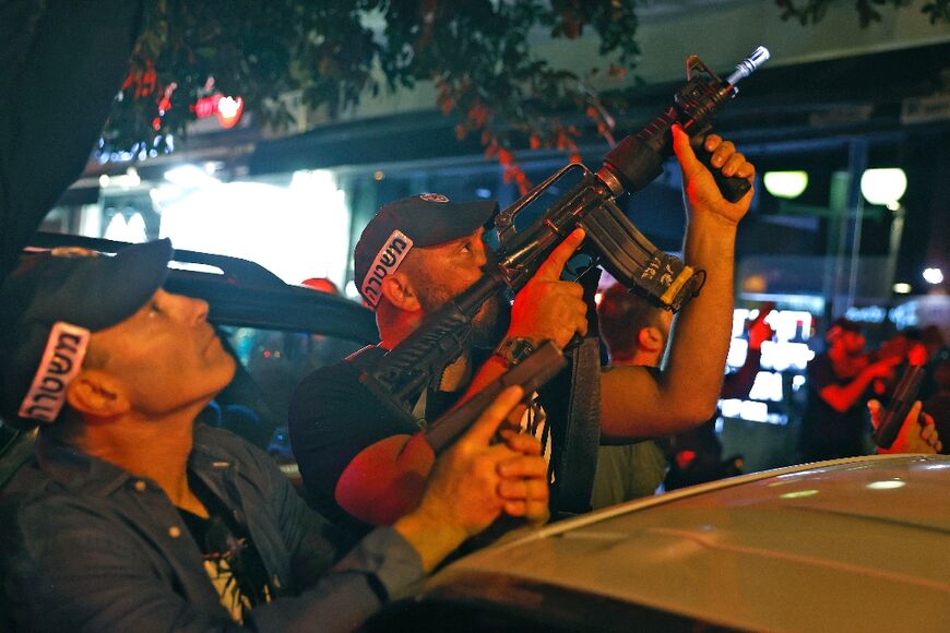 Security forces take aim at the scene of a shooting attack in Dizengoff Street in the centre of Israel's Mediterranean coastal city of Tel Aviv on April 7, 2022