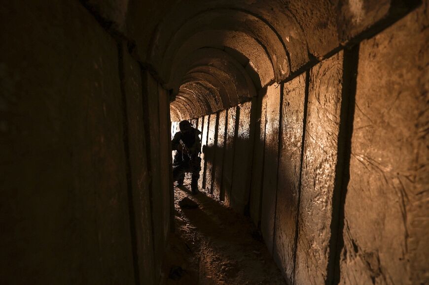 A member of the Palestinian Islamic Jihad militant group walks in a tunnel in the Gaza strip, on April 17, 2022, during a media tour amid escalating violence with Israel