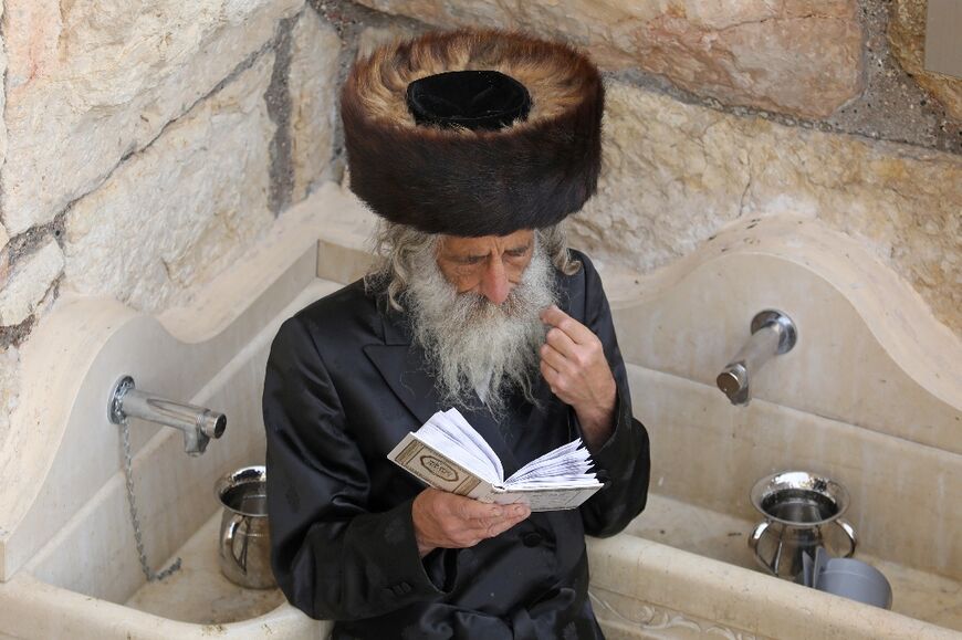 A Jewish worshipper takes part in prayers during the Passover holiday at the Western Wall in Jerusalem's Old City on April 18, 2022