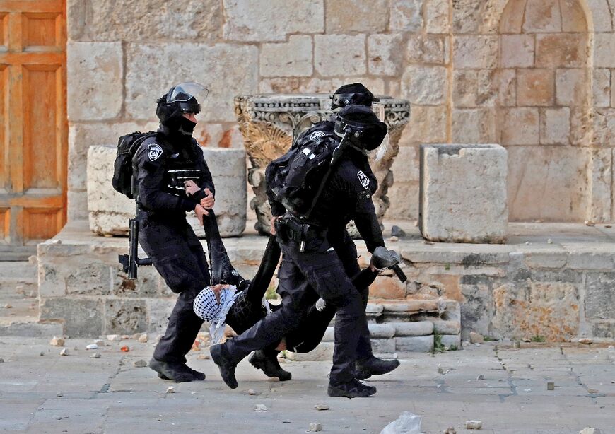 Israeli police arrest a Palestinian demonstrator at Jerusalem's Al-Aqsa mosque compound