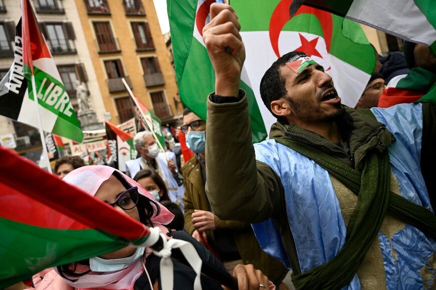 Demonstrators in Madrid wave Western Sahara flags during a protest against the Spanish government's support for Morocco's autonomy plan for the territory, on March 26, 2022