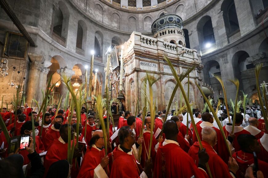 Roman Catholic clergy take part in the Palm Sunday procession at the Church of the Holy Sepulchre in Jerusalem's Old City, on April 10