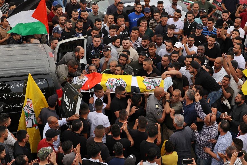 Palestinians carry the body of Ahmed Ibrahim Oweidat, who was killed during an Israeli forces operation, during his funeral in Jericho in the Israeli-occupied West Bank, on April 26, 2022