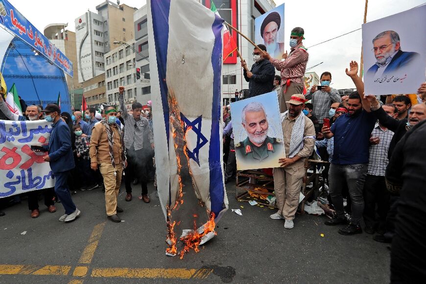 Iranians set an Israeli flag on fire in Tehran at a Quds Day rally 